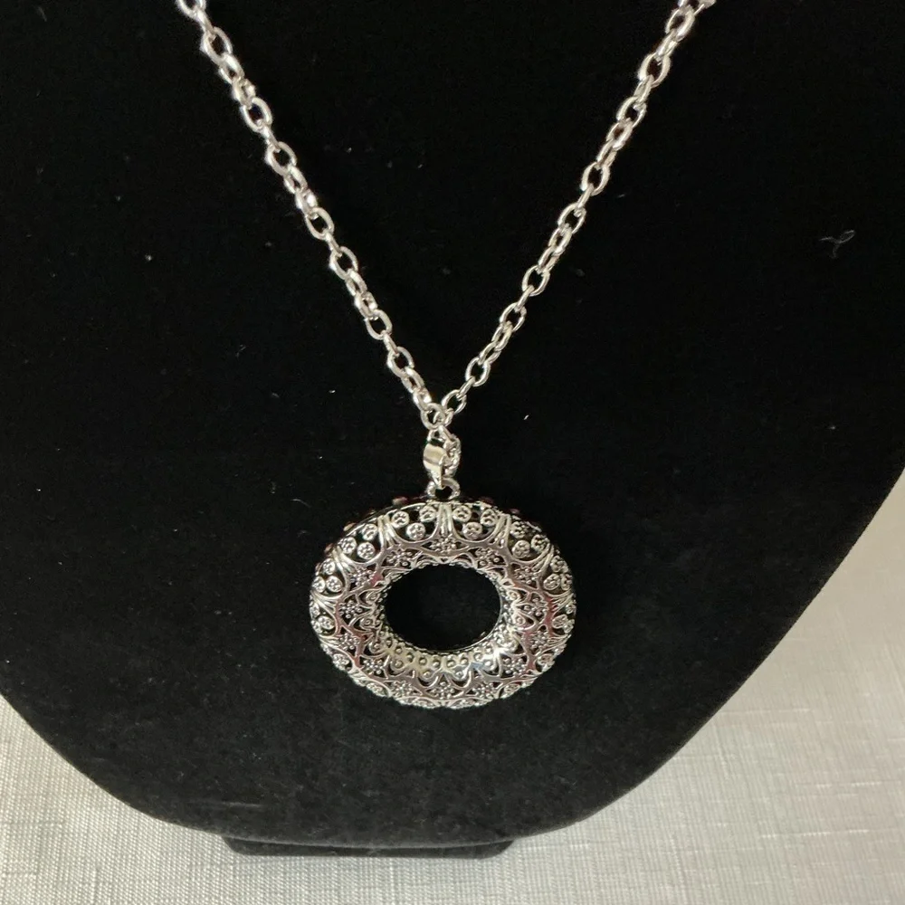 Pink Rhinestone Silver Tone Pendant Necklace intertwined within