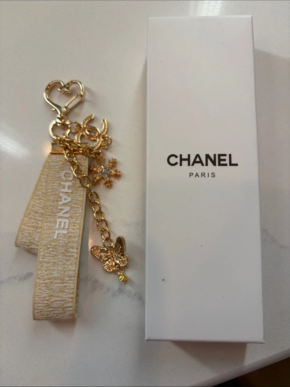 Beige and Gold Logo Strap Keychain with Charms