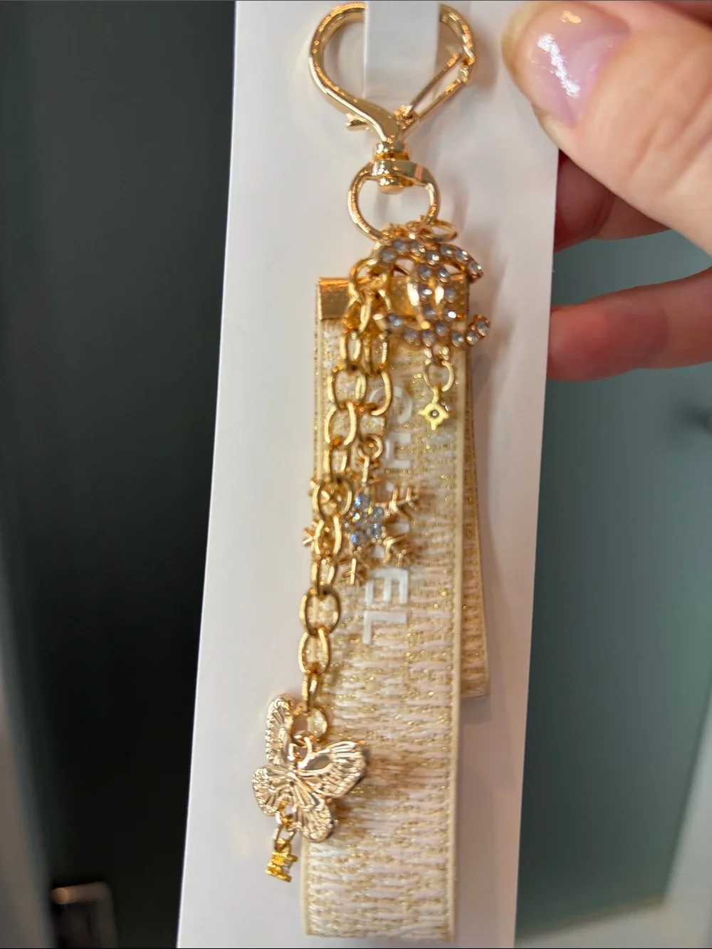 Beige and Gold Logo Strap Keychain with Charms