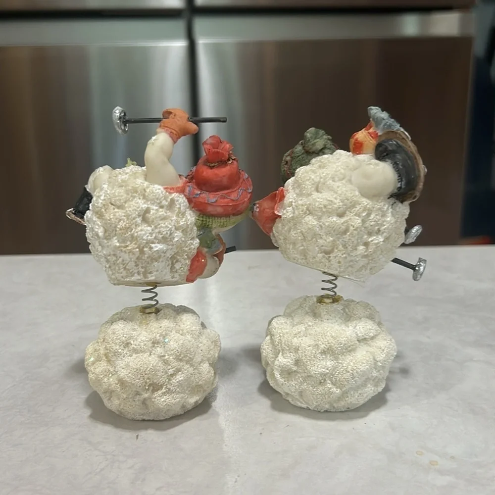 Set of snowmen sitting on snowball skiing