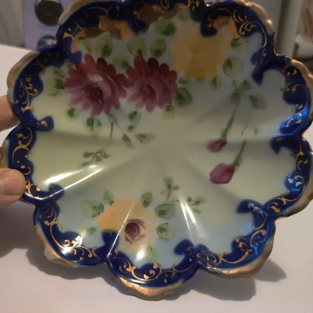 Bowl, handpainted floral from the 1960's .Three footed and trimmed with gold.