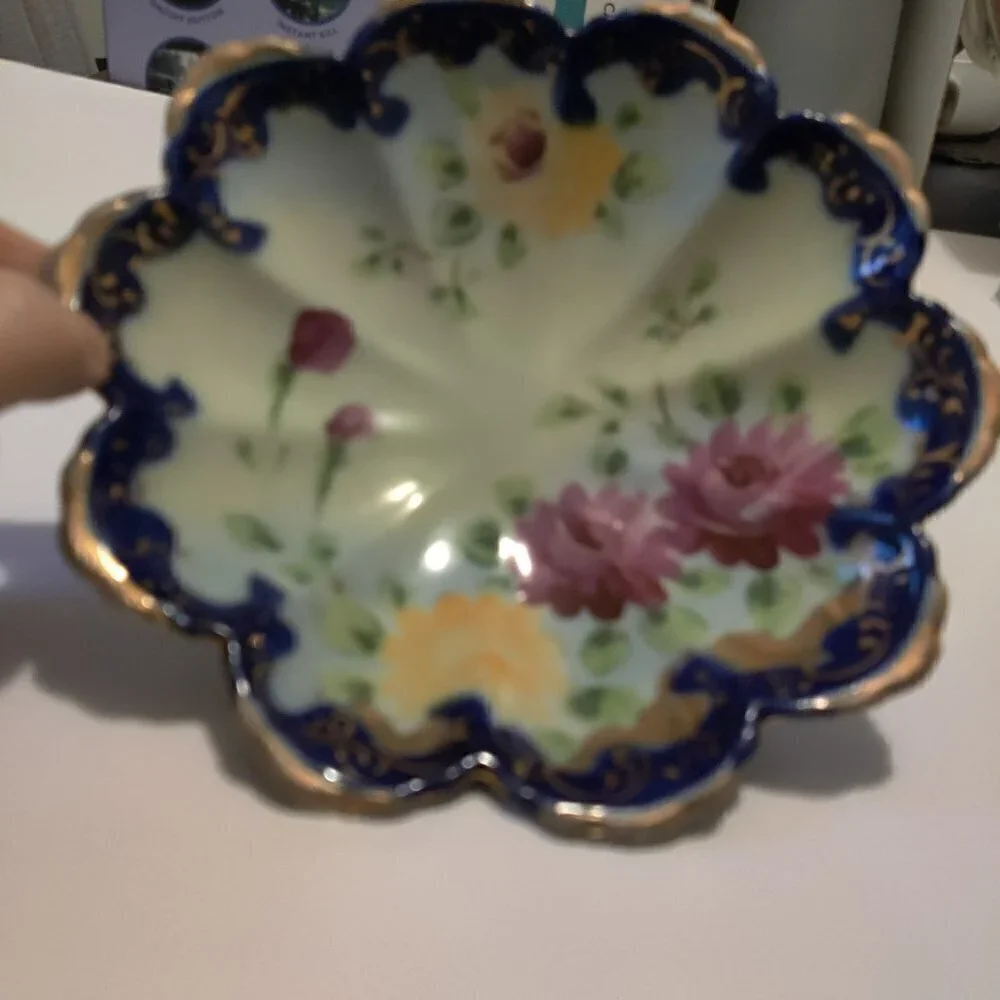 Bowl, handpainted floral from the 1960's .Three footed and trimmed with gold.