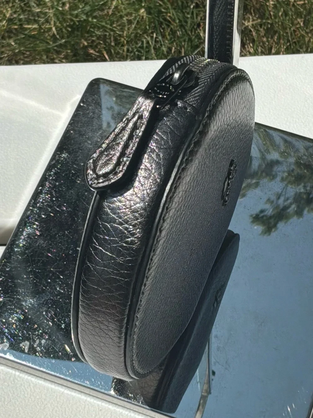 COACH Metallic Silver Gray Round case.