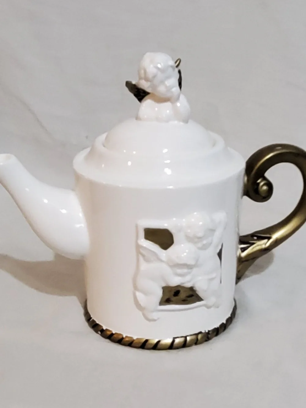 White Porcelain Teapot with Gold Accents and Cherub Design