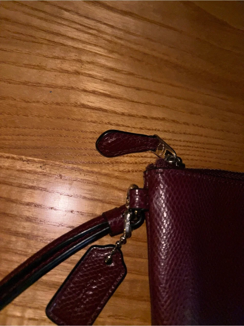 Coach Burgundy Pebbled Leather Wristlet with Gold Logo